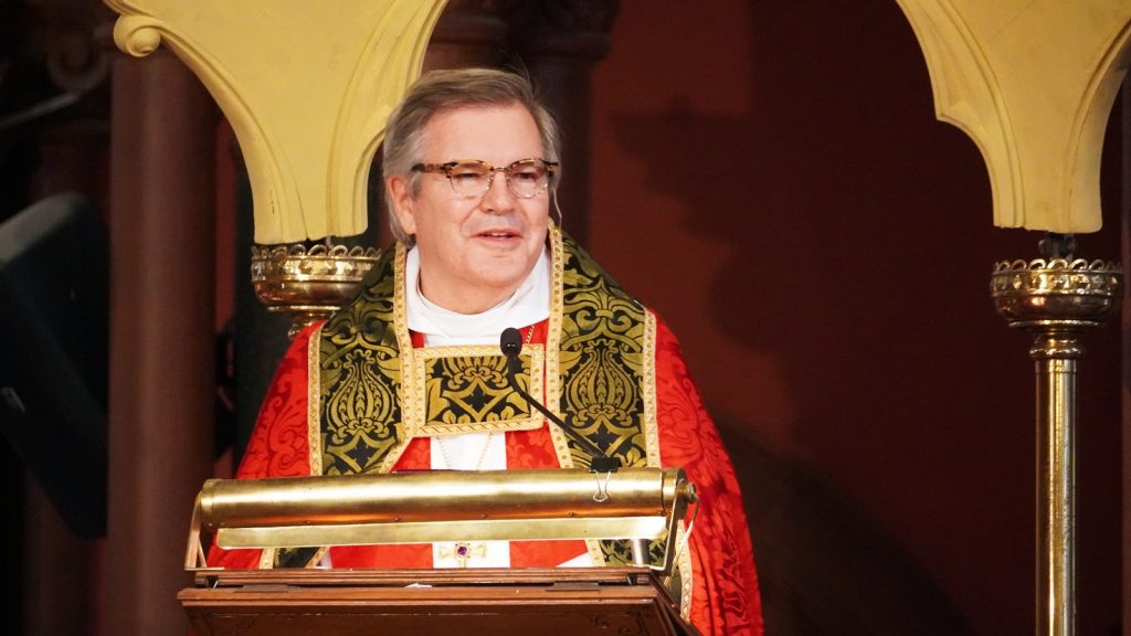 Bishop delivering sermon from pulpit