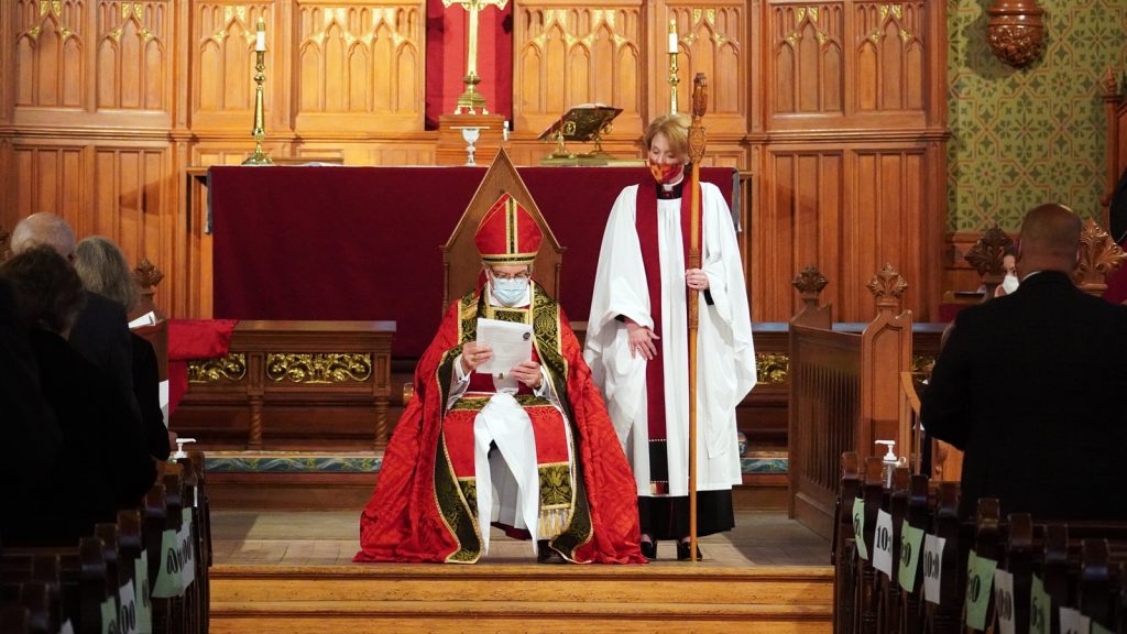 Bishop seated at front of church